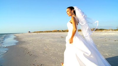 stock-footage-beautiful-bride-walking-on-the-beach-after-her-wedding-filmed-at-fps